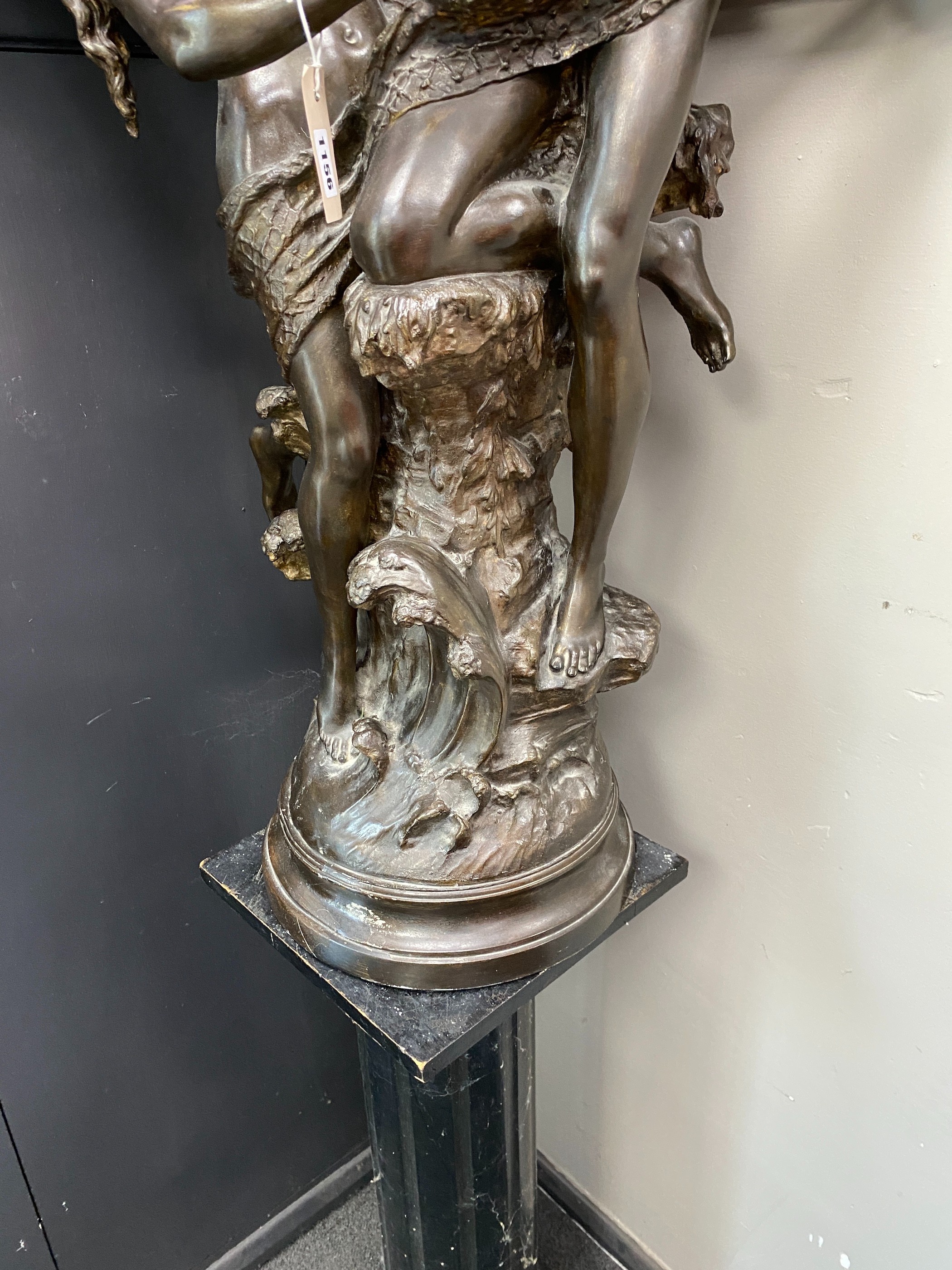 A bronzed metal group of a dancing couple on associated wood plinth combined height 170cm